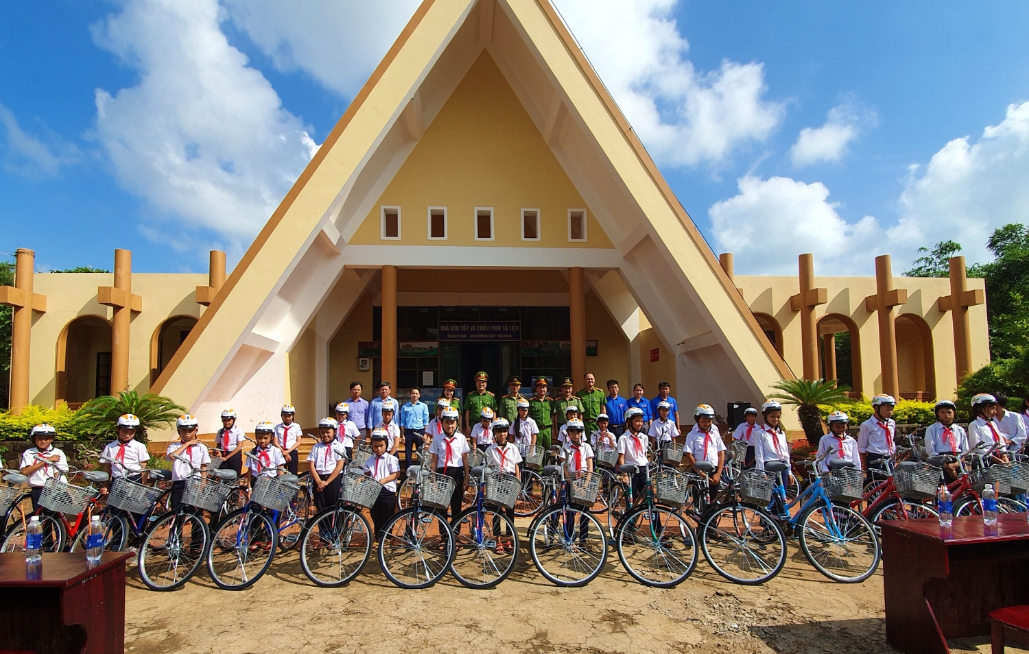 Các học sinh ở huyện Vĩnh Linh nhận xe đạp và mũ bảo hiểm